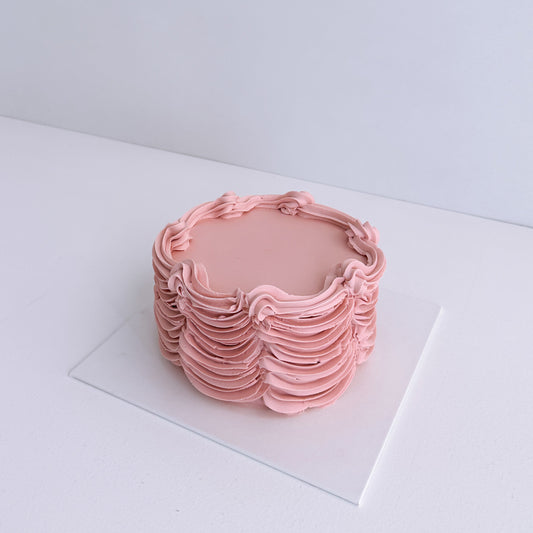 Pink woven basket on a white surface with a light gray background