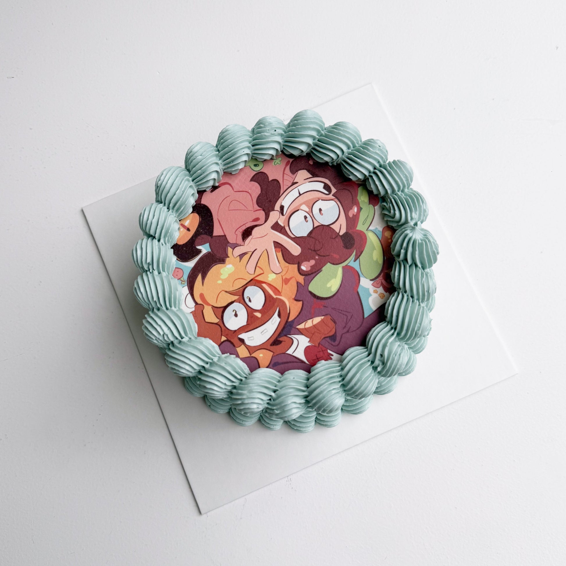 Decorative cake with cartoon character design on a white background